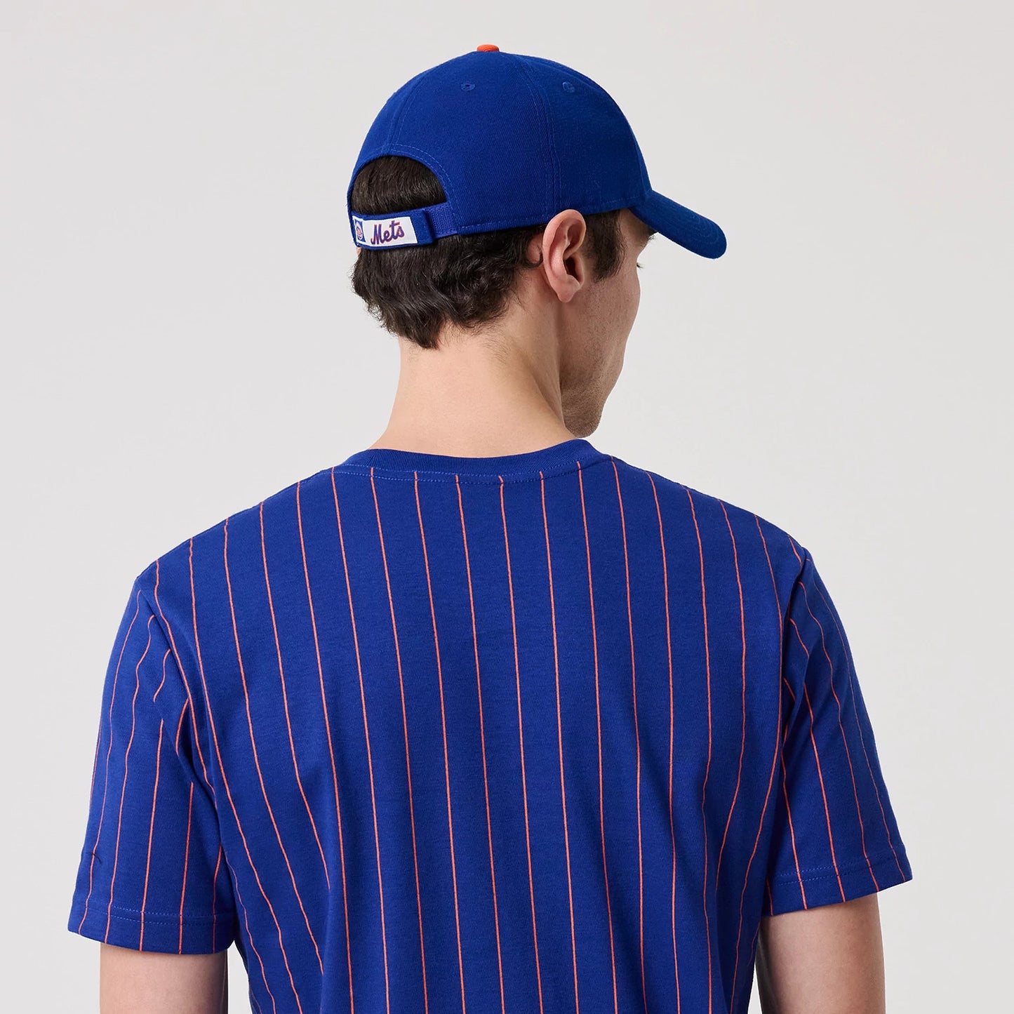 The model is wearing this MLB Pinstripe New York Mets T-Shirt in blue. 6