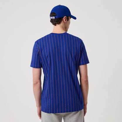 New Era New York Mets MLB Pinstripe Blue T-Shirt, back view showing a vertically striped design in orange on a blue background, worn by a model with a blue cap featuring the embroidered MLB logo on the back strap.