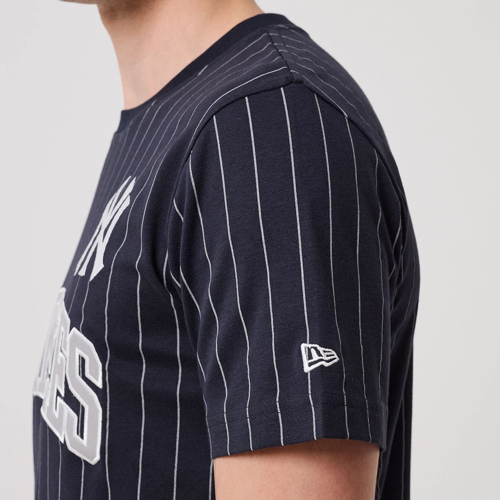 The model is wearing this MLB Pinstripe New York Yankees T-Shirt in navy. 6