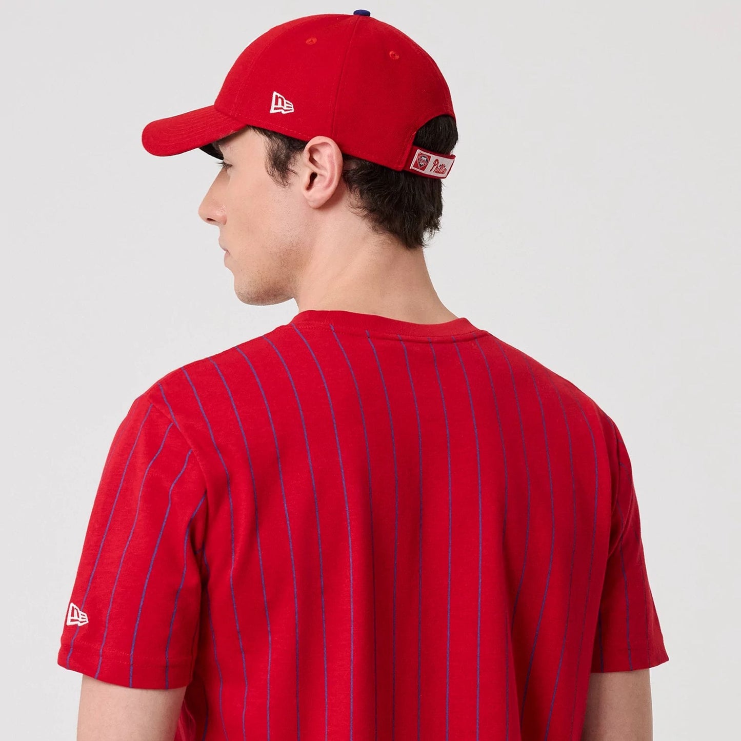The model is wearing this MLB Pinstripe Philadelphia Phillies T-Shirt in red. 7