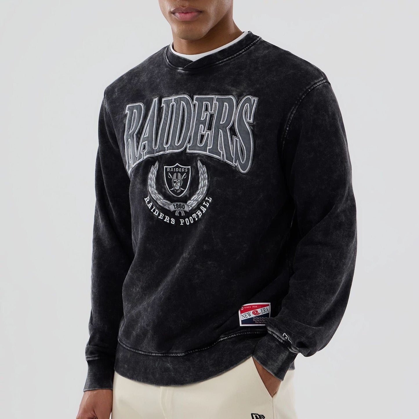 The model is wearing this NFL Las Vegas Raiders Crew Neck Sweater in black. 4