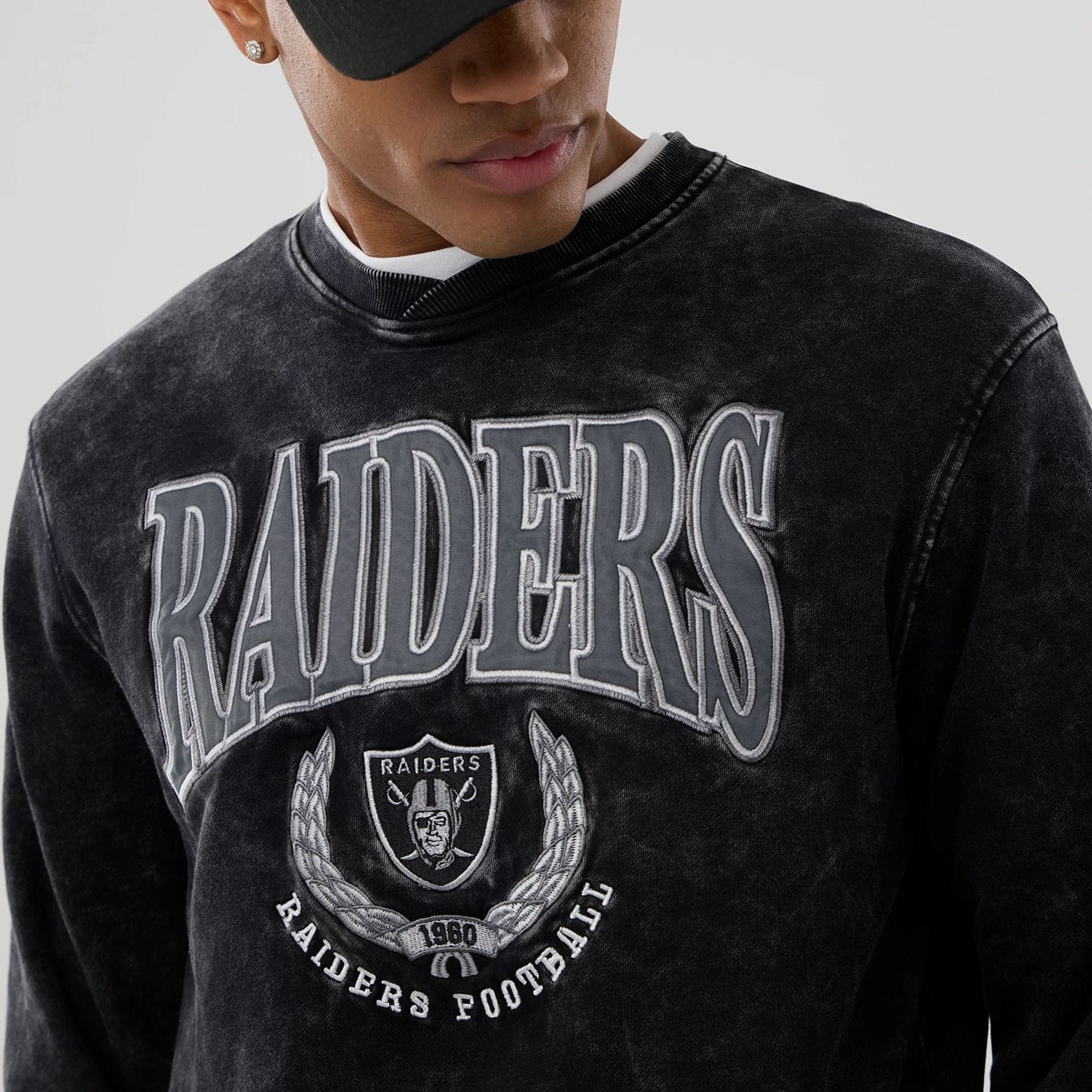 The model is wearing this NFL Las Vegas Raiders Crew Neck Sweater in black. 6