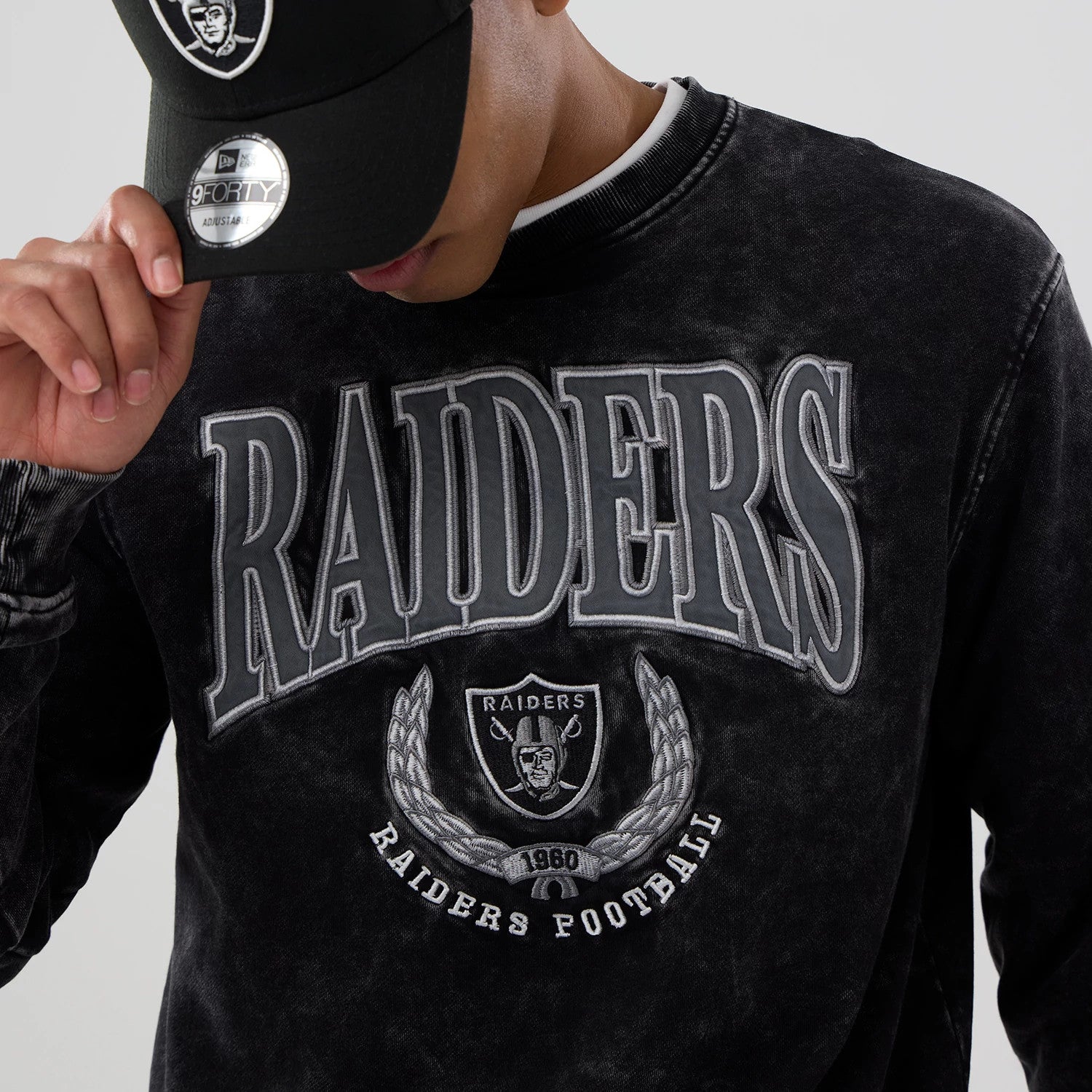The model is wearing this NFL Las Vegas Raiders Laurel Wreath Crew Neck Sweater in black. 3