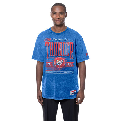 New Era Oklahoma City Thunder NBA Blue T-Shirt, front view on-model revealing red Thunder lettering and OKC logo printed across the chest, with year 2008 displayed, complemented by short sleeves and a crew neckline.