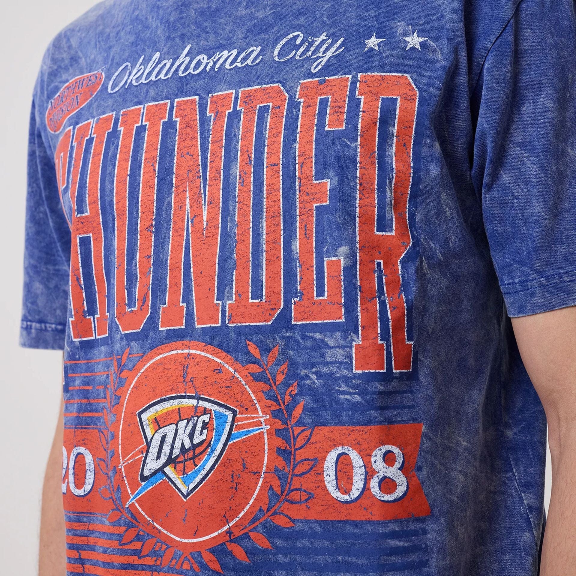 The model is wearing this NBA Oklahoma City Thunder T-Shirt in blue. 3