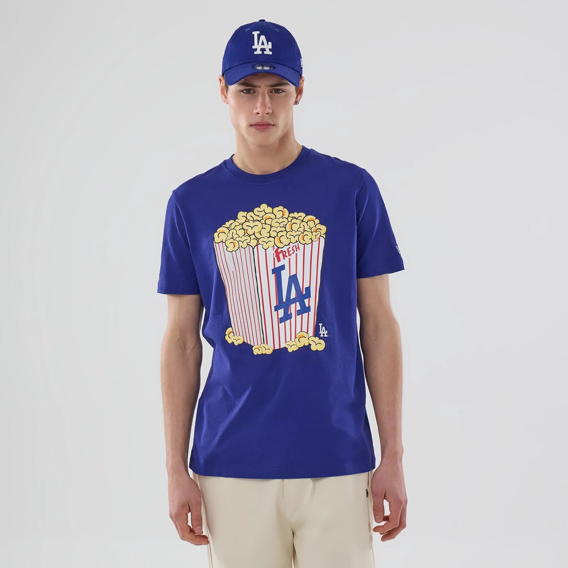 The model is wearing this MLB Popcorn LA Dodgers T-Shirt in dark blue. 1