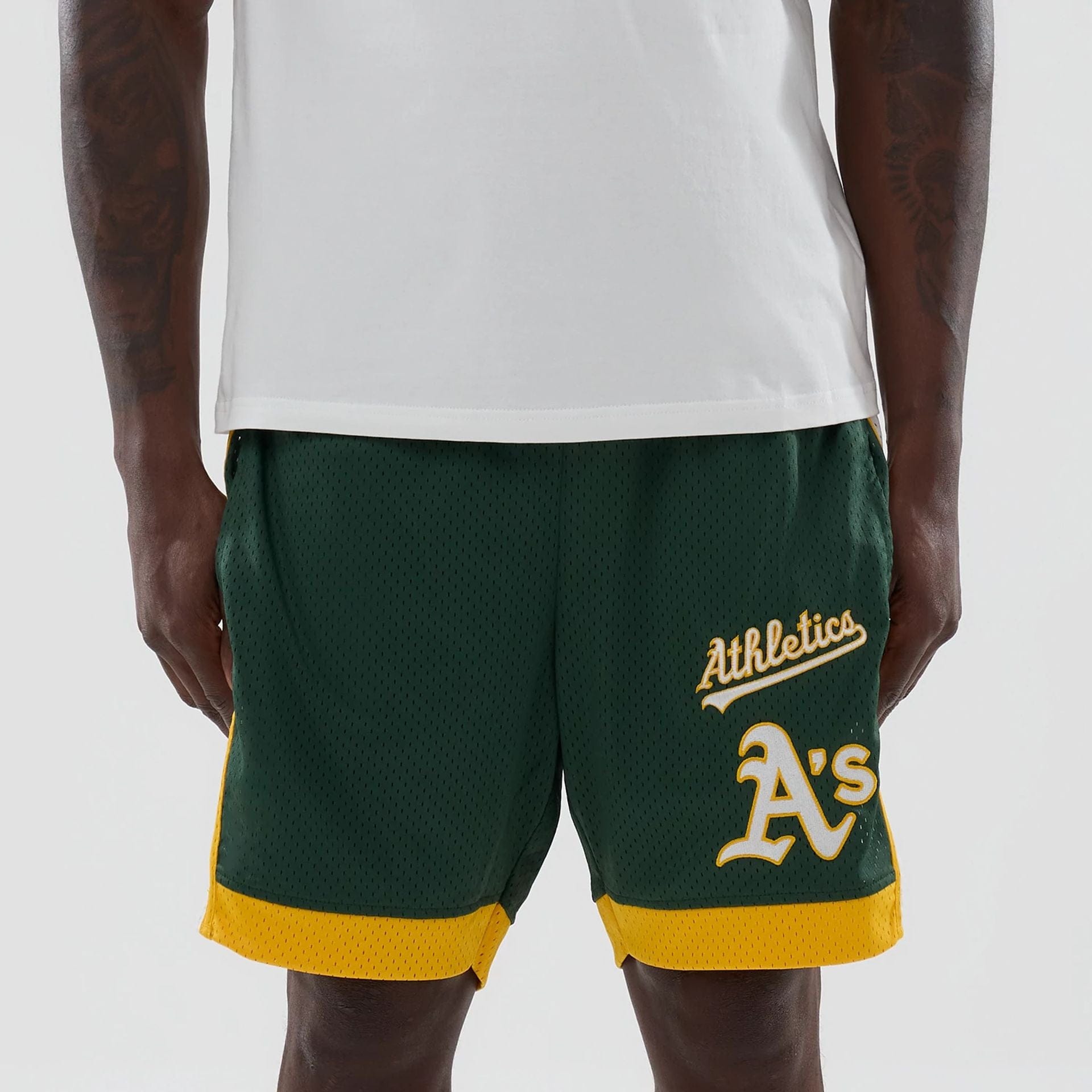 The model is wearing these MLB Athletics Mesh Shorts in dark green. 2
