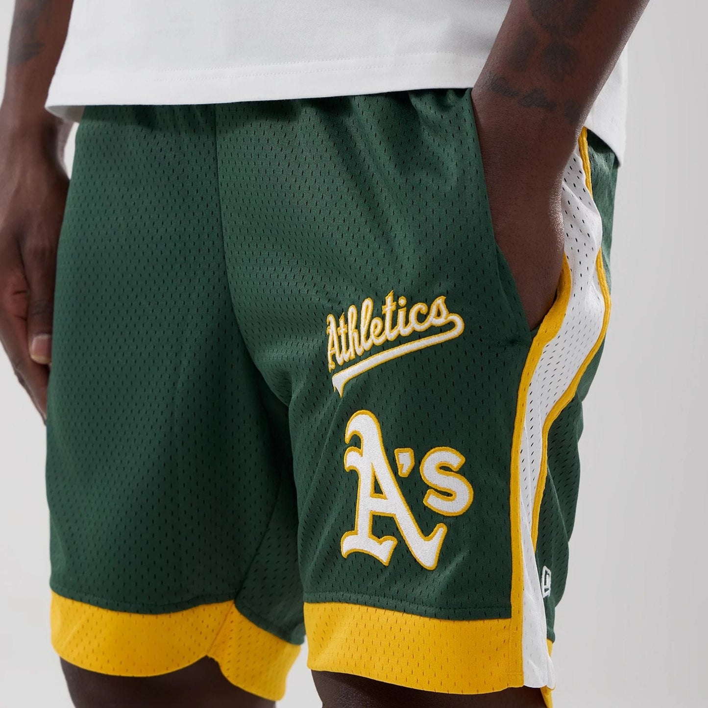 The model is wearing these MLB Athletics Mesh Shorts in dark green. 3
