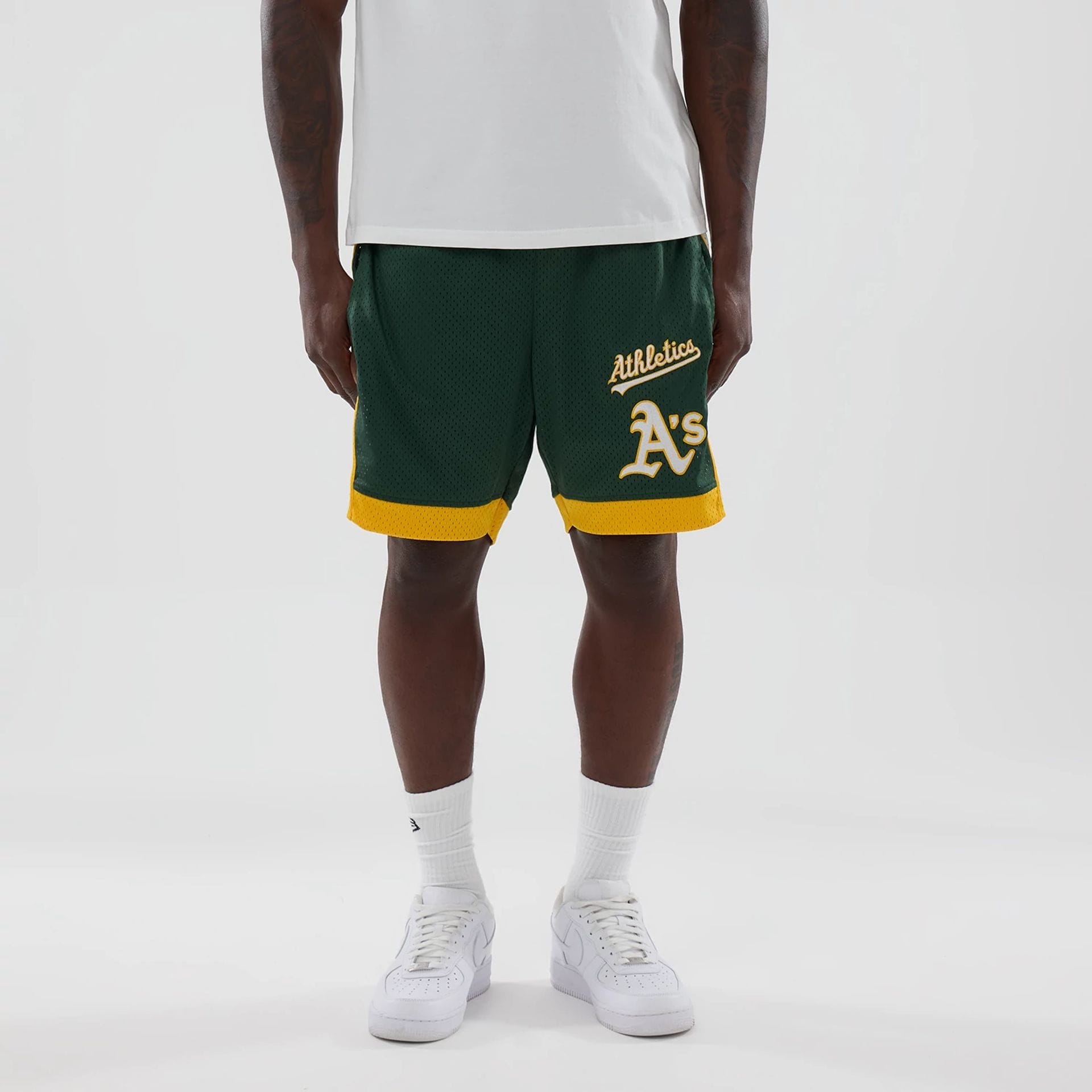 The model is wearing these MLB Athletics Mesh Shorts in dark green. 1