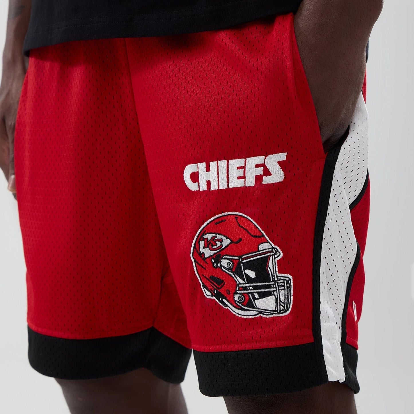 The model is wearing these NFL Kansas City Chiefs Mesh Shorts in red. 2