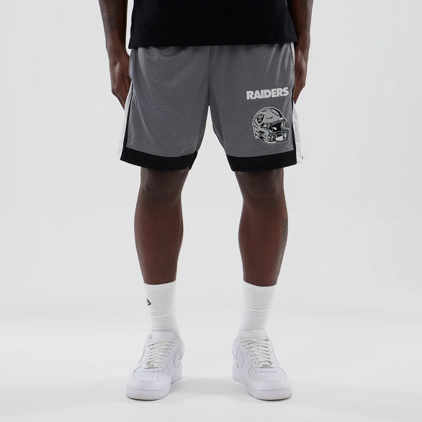 The model is wearing these NFL Las Vegas Raiders Mesh Shorts in grey. 1