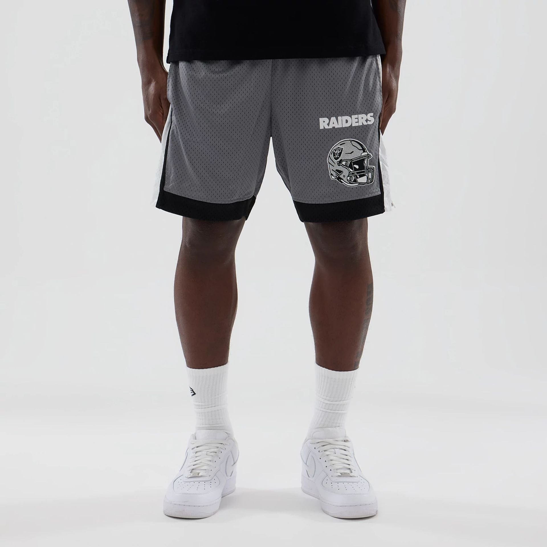 The model is wearing these NFL Las Vegas Raiders Mesh Shorts in grey. 1