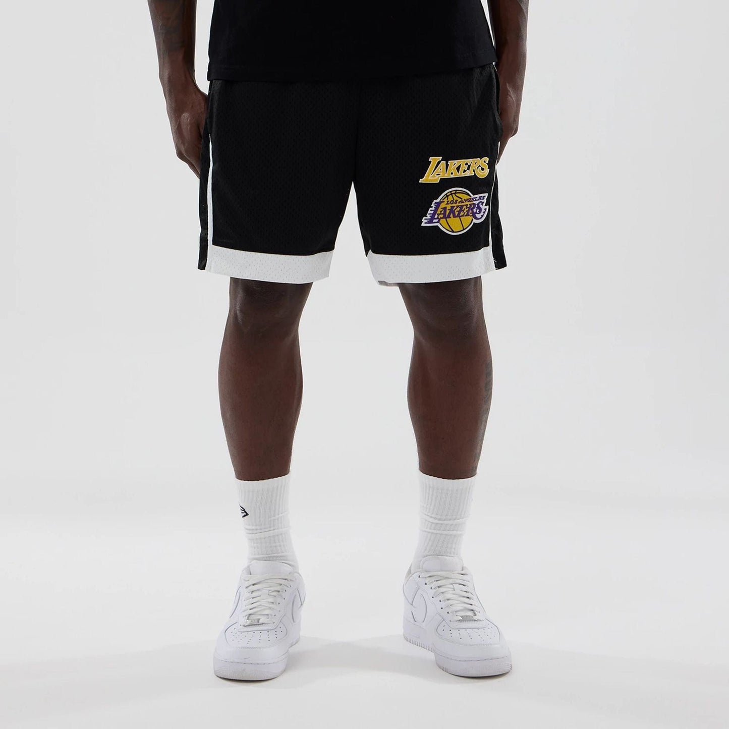 The model is wearing these NBA LA Lakers Mesh Shorts in black. 1