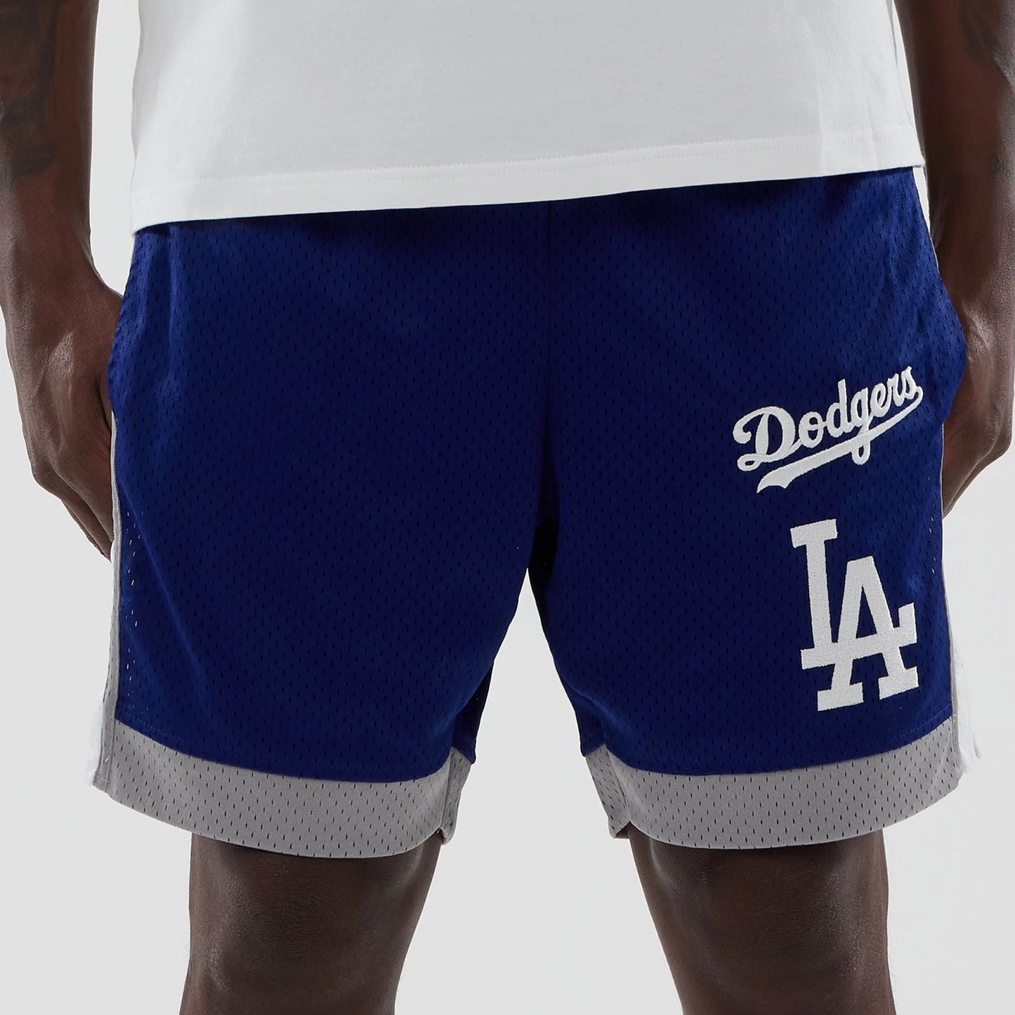 The model is wearing these MLB LA Dodgers Mesh Shorts in dark blue. 2