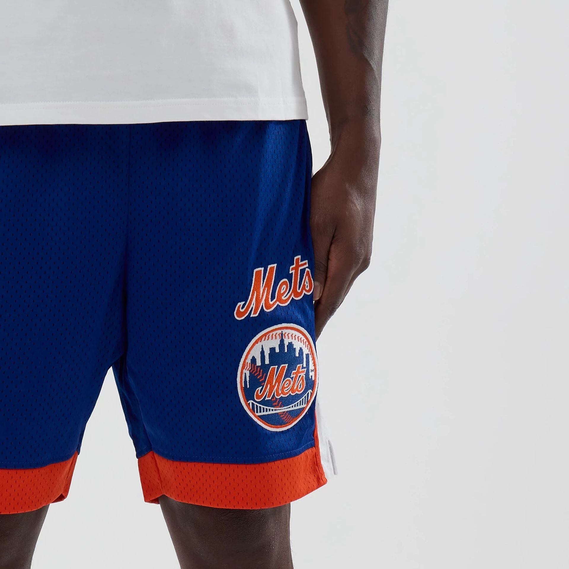 The model is wearing these MLB New York Mets Mesh Shorts in blue. 5