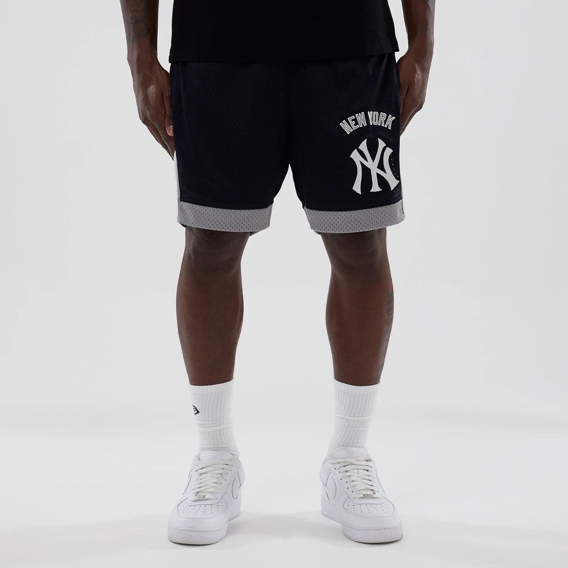 The model is wearing these MLB New York Yankees Mesh Shorts in navy. 1