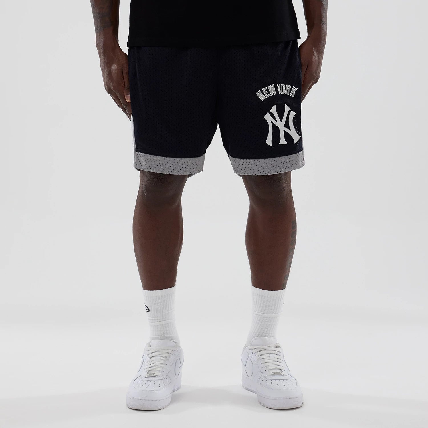 The model is wearing these MLB New York Yankees Mesh Shorts in navy. 1
