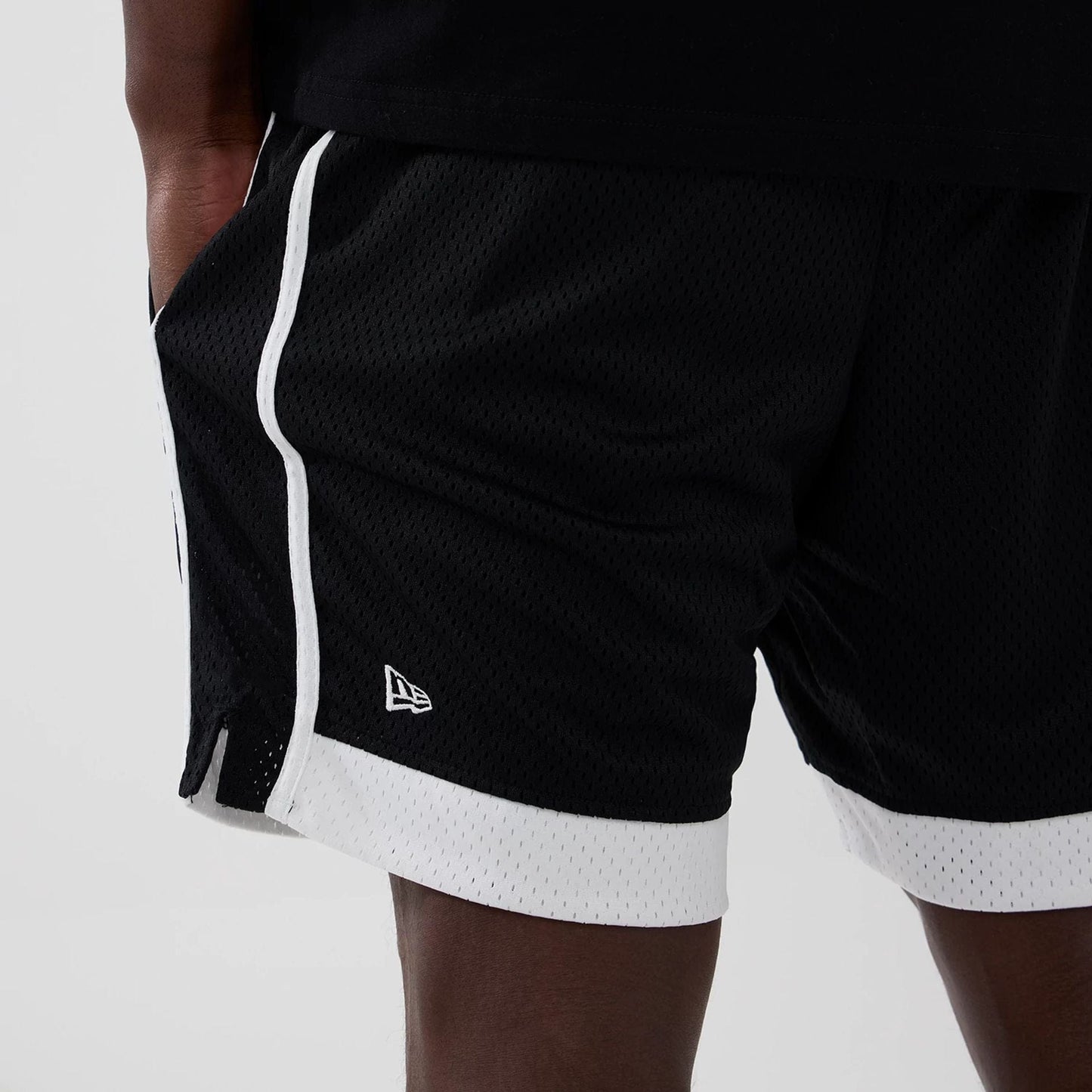 The model is wearing these MLB New York Yankees Mesh Shorts in black. 4