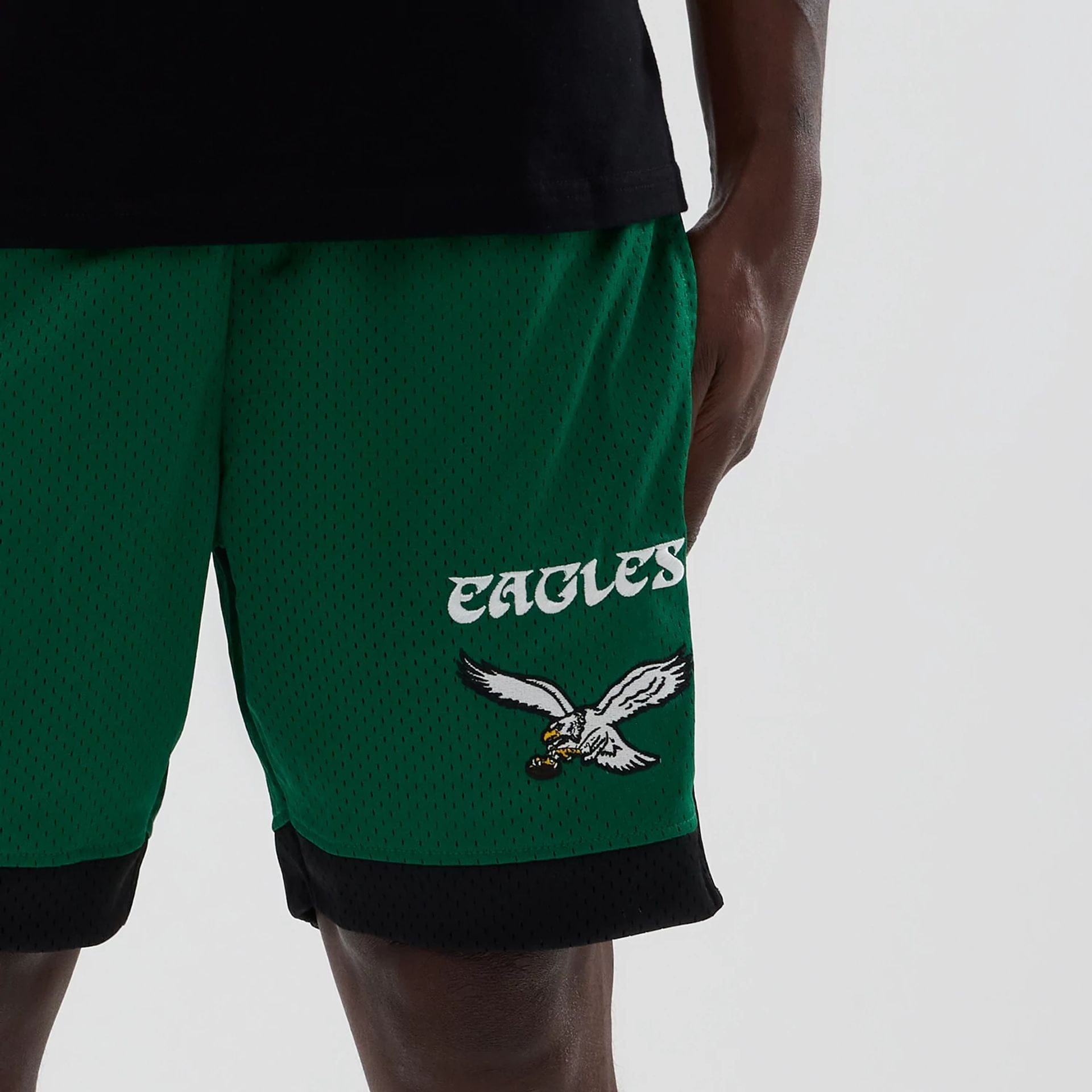 The model is wearing these NFL Philadelphia Eagles Mesh Shorts in green. 5