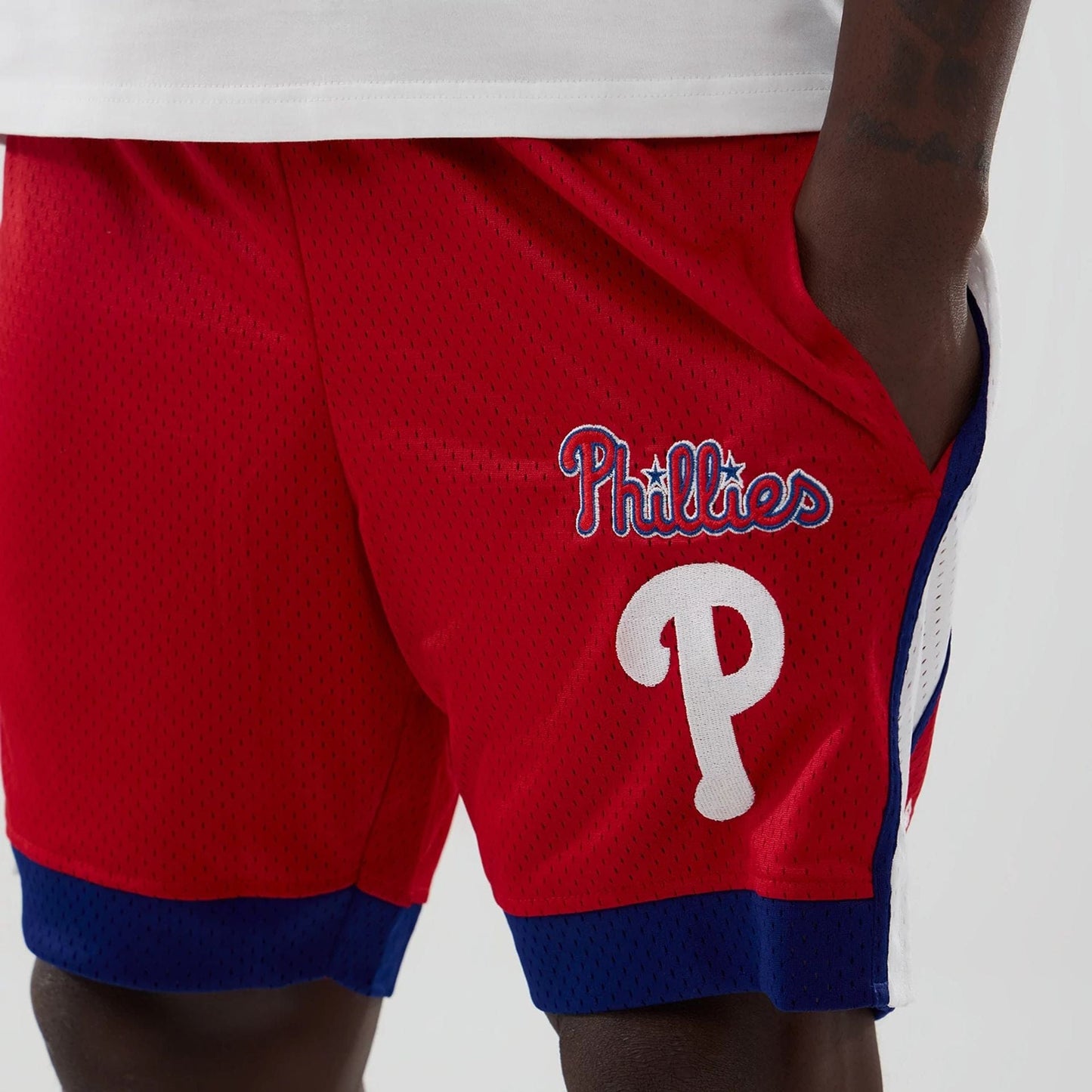 The model is wearing these MLB Philadelphia Phillies Mesh Shorts in red. 3