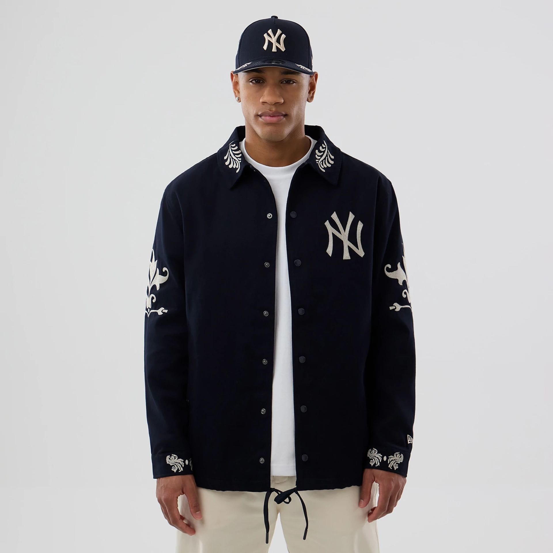 The model is wearing this MLB Script New York Yankees Coach Jacket in navy. 1