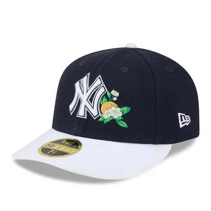 Yankees MLB Spring Training 2026 Navy Low Profile New Era 59FIFTY Fitted Cap, front view with a white embroidered NY logo and orange blossom detail on the navy crown, a contrasting white visor, and gold 59FIFTY size sticker.