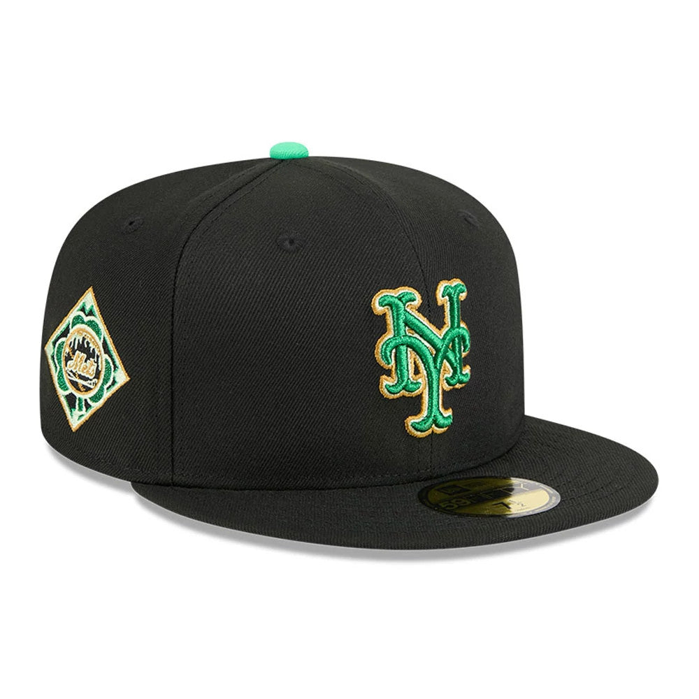 New York Mets MLB Saint Patrick's Day Black New Era 59FIFTY Fitted Cap, three-quarter view with a green and gold embroidered NY logo on the front panel, a green top button, matching side patch, and a gold 59FIFTY size sticker on the visor.
