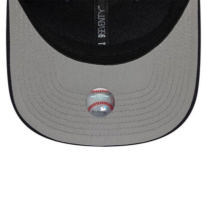 New York Yankees MLB Circles Navy New Era 9SEVENTY Stretch Snap Adjustable Cap, inside view showing the grey undervisor with a baseball graphic sticker and black taping featuring the 9SEVENTY branding.