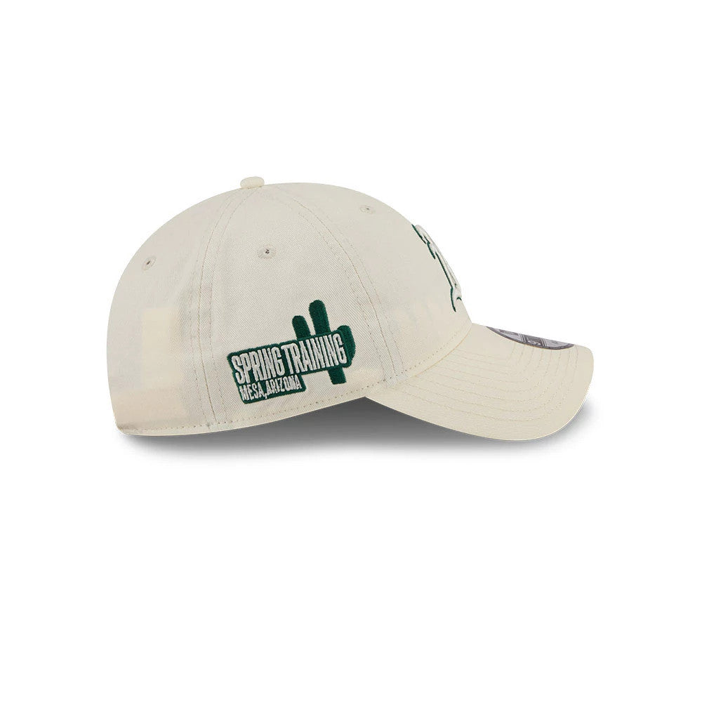 Athletics MLB Colours White New Era 9TWENTY Adjustable Cap, side view showing an embroidered green Spring Training logo and cactus silhouette on the left side of the light-coloured unstructured crown.