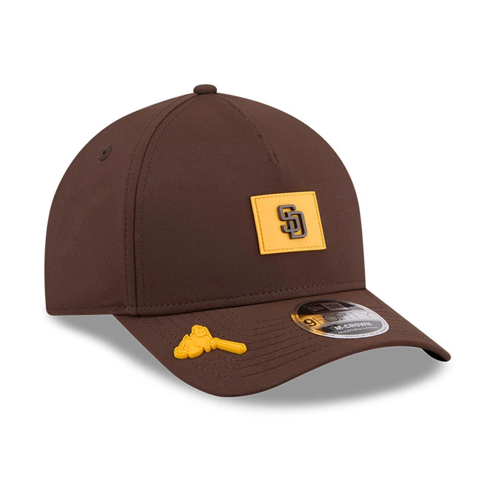San Diego Padres MLB Clubhouse Dark Brown New Era 9FORTY M-Crown A-Frame Adjustable Cap, three-quarter view showing the raised yellow SD logo on the front panel, brown curved visor with a 9FORTY size sticker, and a yellow pin on the visor.