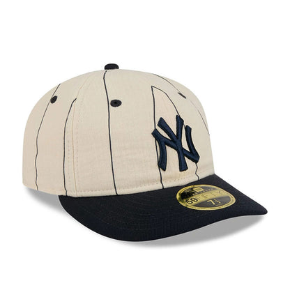 New York Yankees MLB Linen Cream Retro Crown New Era 59FIFTY Fitted Cap, three-quarter view showing the raised navy NY logo on the front panel, black visor with a gold 59FIFTY size sticker, and cream pinstriped crown.