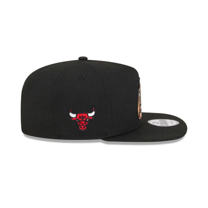 Chicago Bulls NBA Ring Black New Era 9FIFTY A-Frame Snapback Adjustable Cap, side view showing the red and white embroidered Bulls logo on the structured black crown, with a flat black visor and a 9FIFTY size sticker on the top.