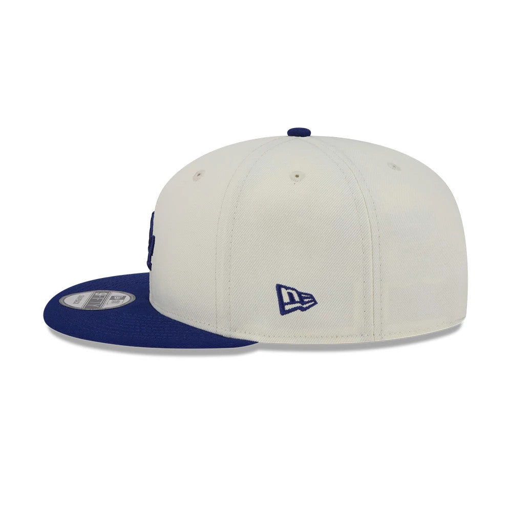 LA Dodgers MLB Localized White New Era 9FIFTY Snapback Adjustable Cap, side view with the blue embroidered New Era flag logo on the left side, featuring a blue flat visor and structured white crown.