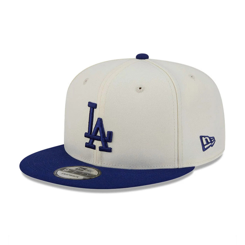 LA Dodgers MLB Localized White New Era 9FIFTY Snapback Adjustable Cap, front view showing the blue raised embroidered LA logo on the front panel, with a contrasting blue visor and a silver 9FIFTY size sticker.