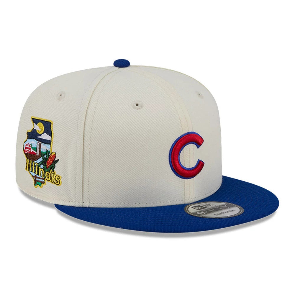 Chicago Cubs MLB Localized White New Era 9FIFTY Snapback Adjustable Cap, front view showing the red and blue embroidered C logo on the off-white crown, with a blue flat visor and 9FIFTY size sticker, and a colourful Illinois side patch.