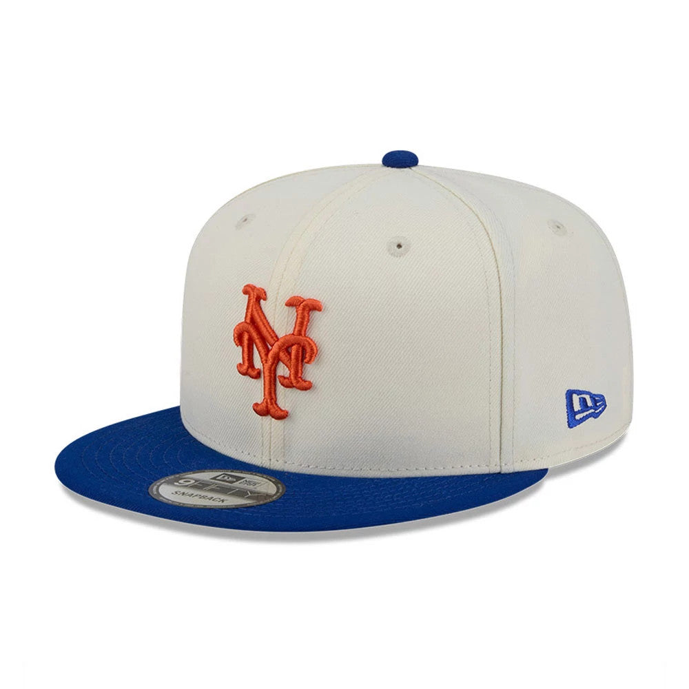 New York Mets MLB Localized White New Era 9FIFTY Snapback Adjustable Cap, three-quarter view showing the raised orange Mets logo on the white front panels, blue flat visor, and blue New Era flag logo on the left side.
