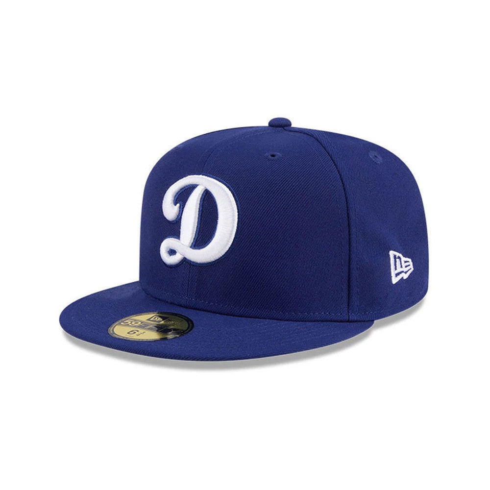 LA Dodgers MLB Cooperstown Hidden Hit Dark Blue New Era 59FIFTY Fitted Cap, three-quarter view showing the white raised embroidered D logo on the front panel, flat dark blue visor with a gold 59FIFTY size sticker.
