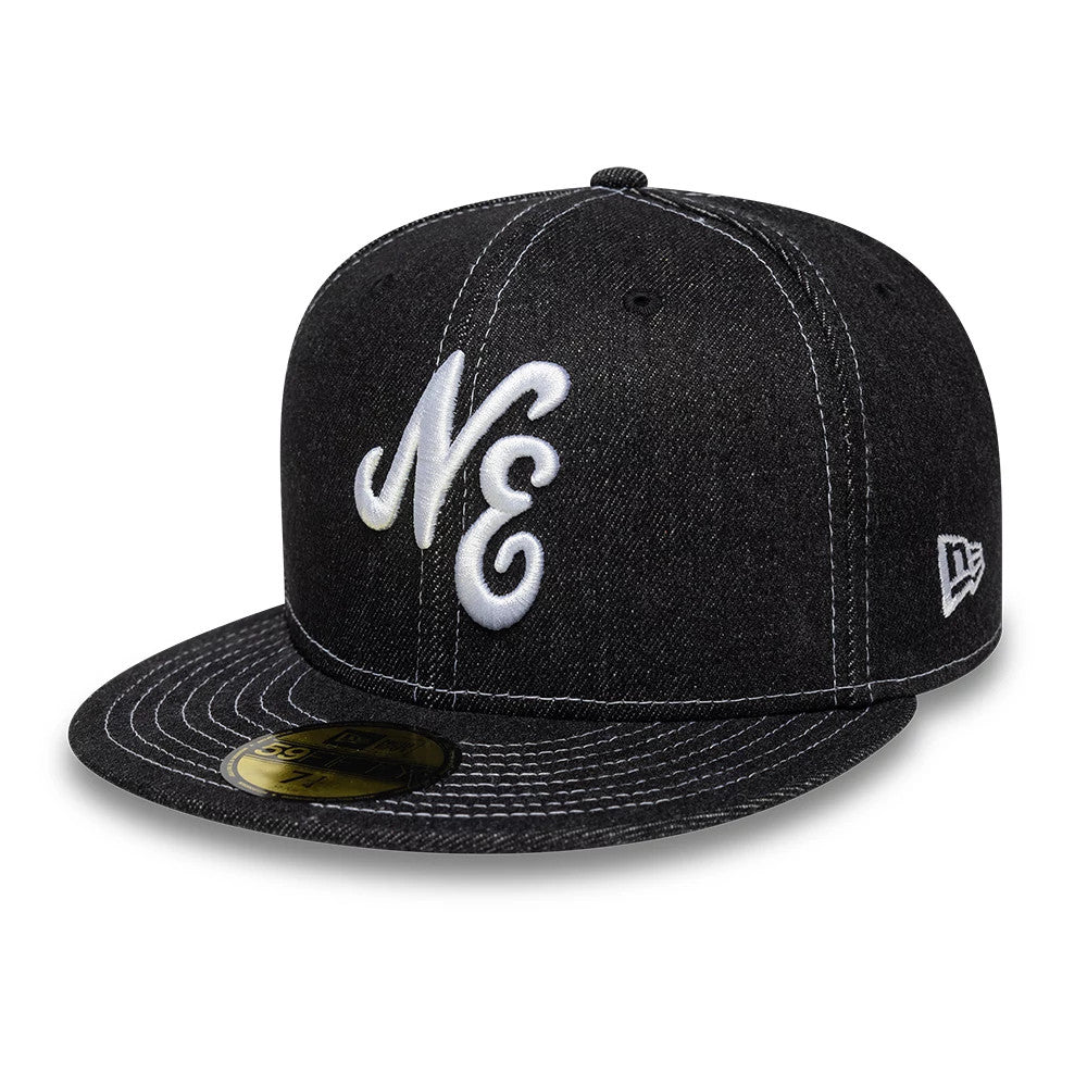 New Era Denim Black 59FIFTY Fitted Cap, three-quarter view showing white raised embroidery NE on the front panel, a flat black denim visor with white stitching, and a gold 59FIFTY size sticker, plus the New Era flag logo on the left side.