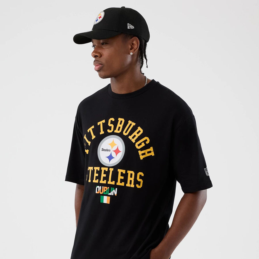 The Male model is wearing Pittsburgh Steelers NFL International Series Games Black Oversized T-Shirt  7