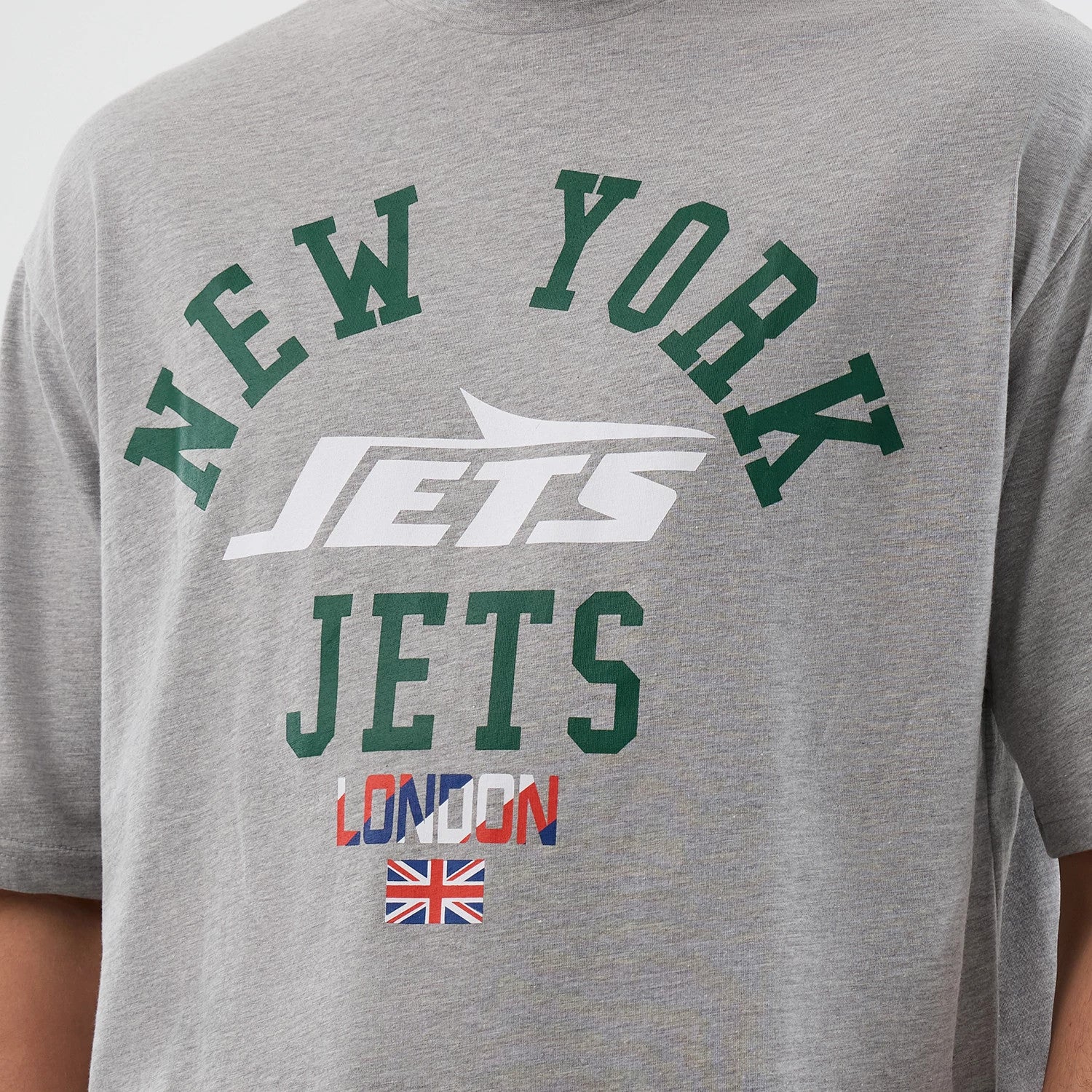 The Male model is wearing New York Jets NFL International Series Games Grey Oversized T-Shirt 3
