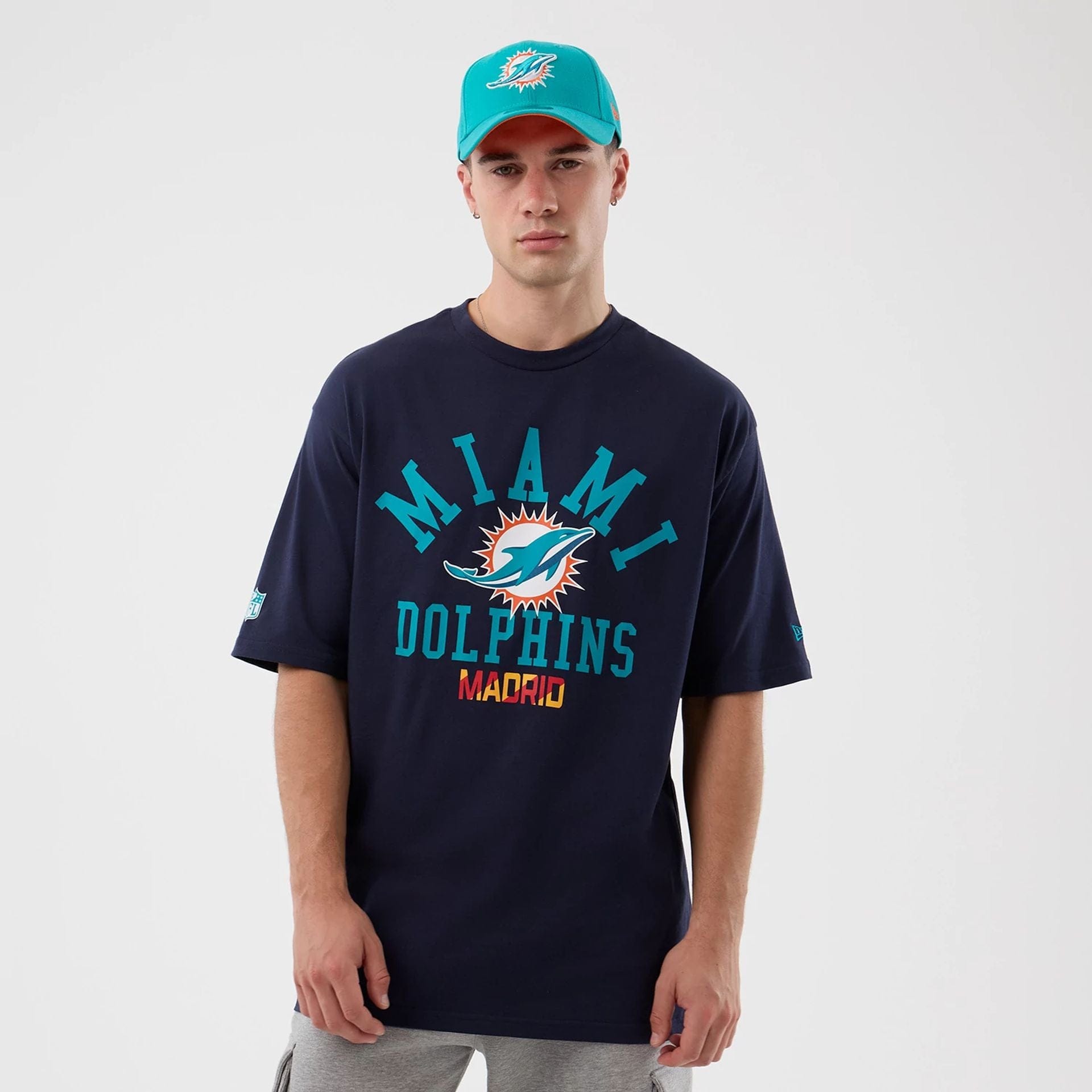 The Male model is wearing Miami Dolphins NFL International Series Games Navy Oversized T-Shirt  1