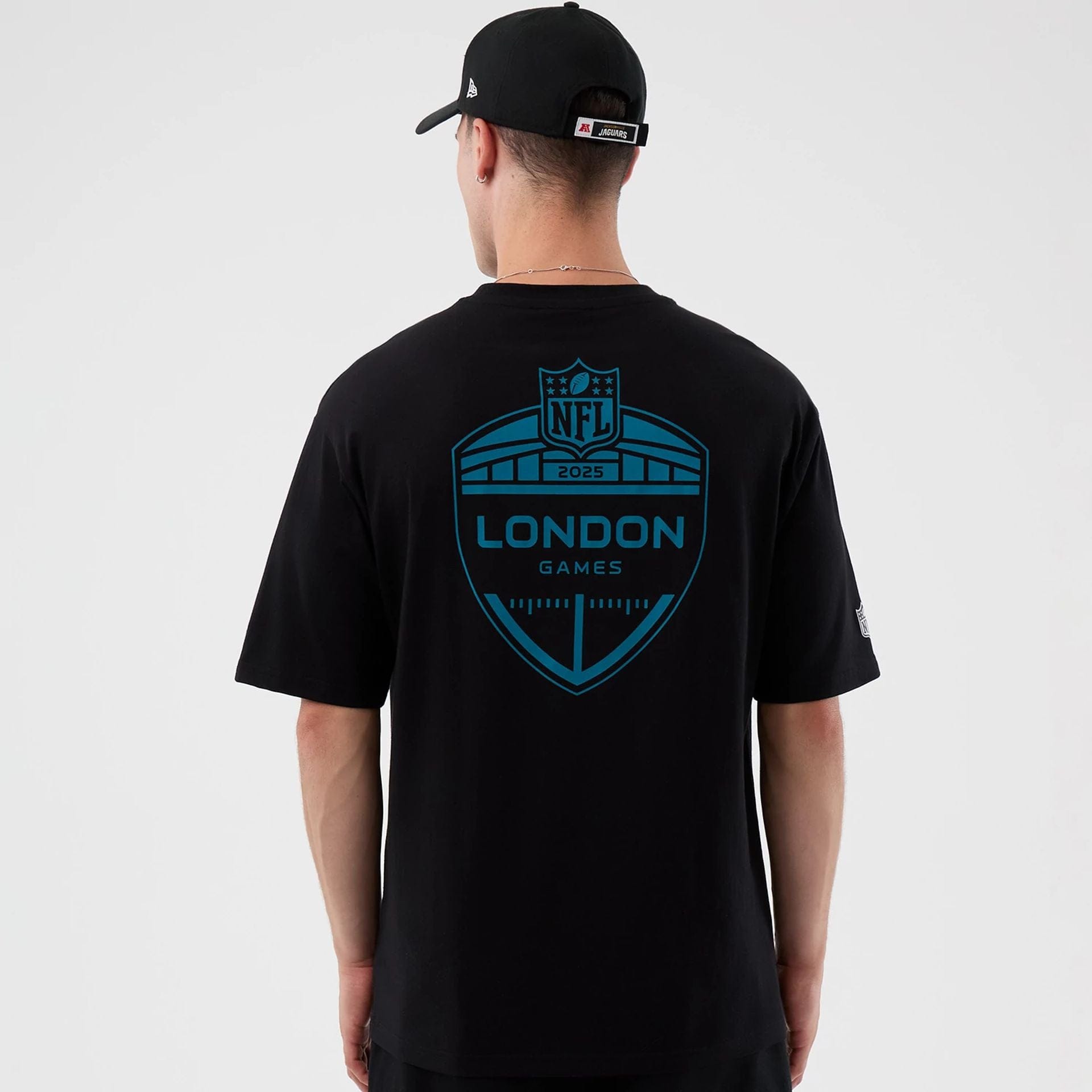 The Male model is wearing Jacksonville Jaguars NFL International Series Games Black Oversized T-Shirt  2