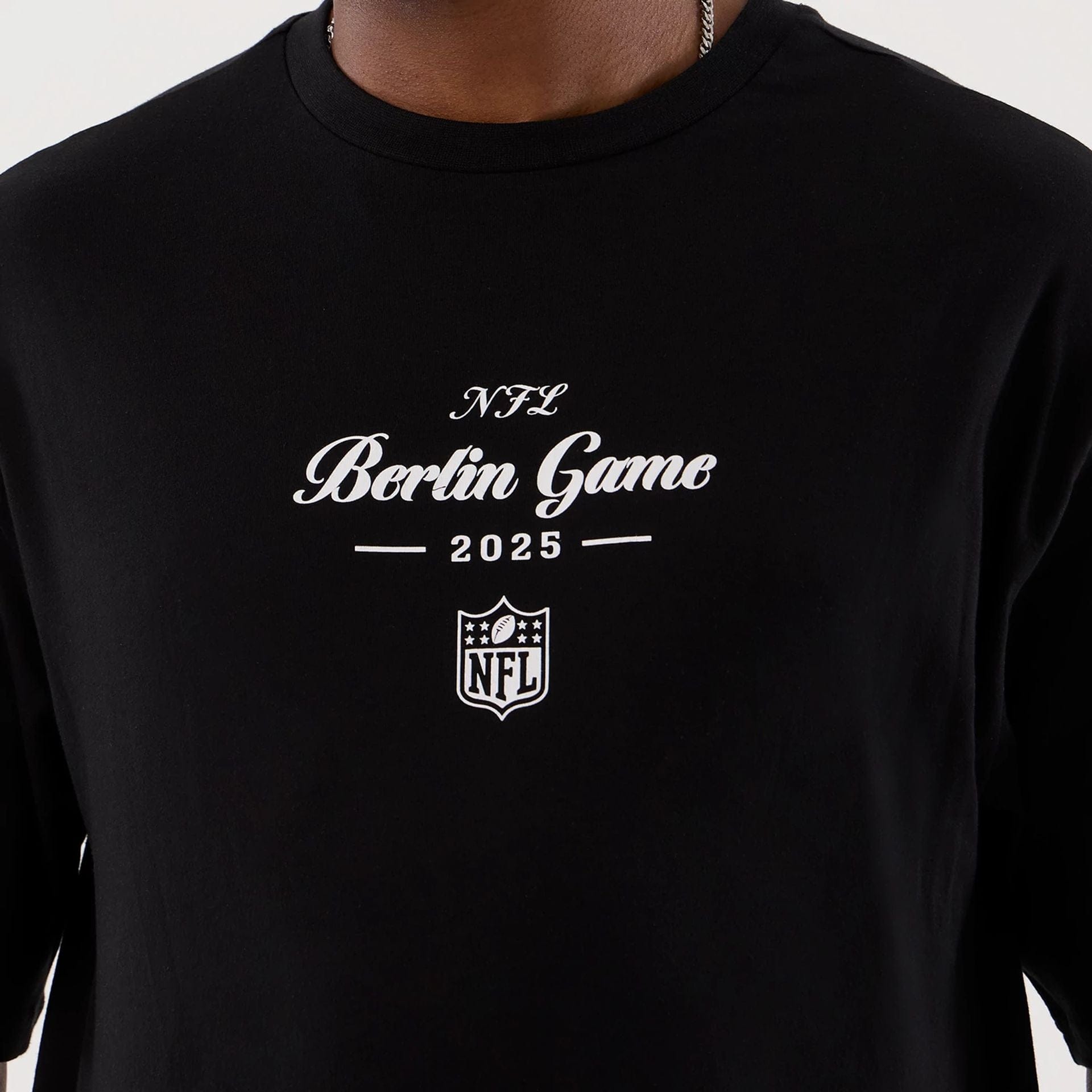 The Male model is wearing Berlin NFL International Series Games Black Oversized T-Shirt  3