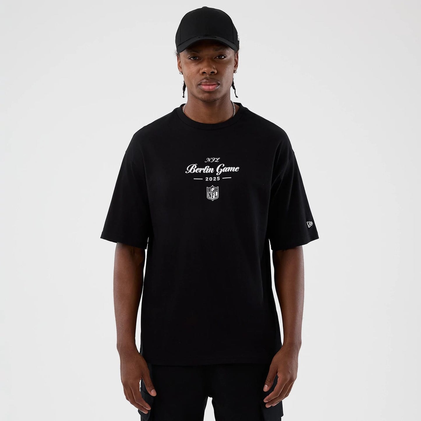 The Male model is wearing Berlin NFL International Series Games Black Oversized T-Shirt 1