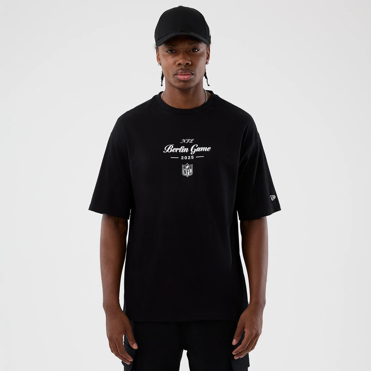 The Male model is wearing Berlin NFL International Series Games Black Oversized T-Shirt 1