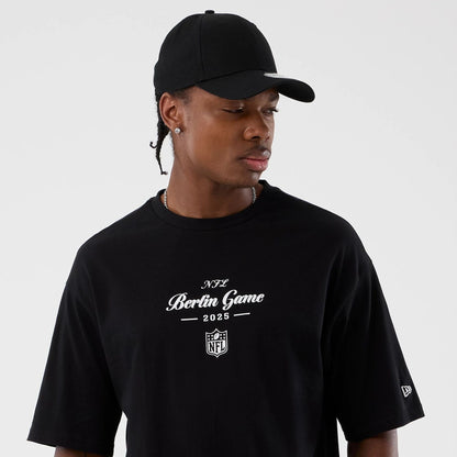 The Male model is wearing Berlin NFL International Series Games Black Oversized T-Shirt  6