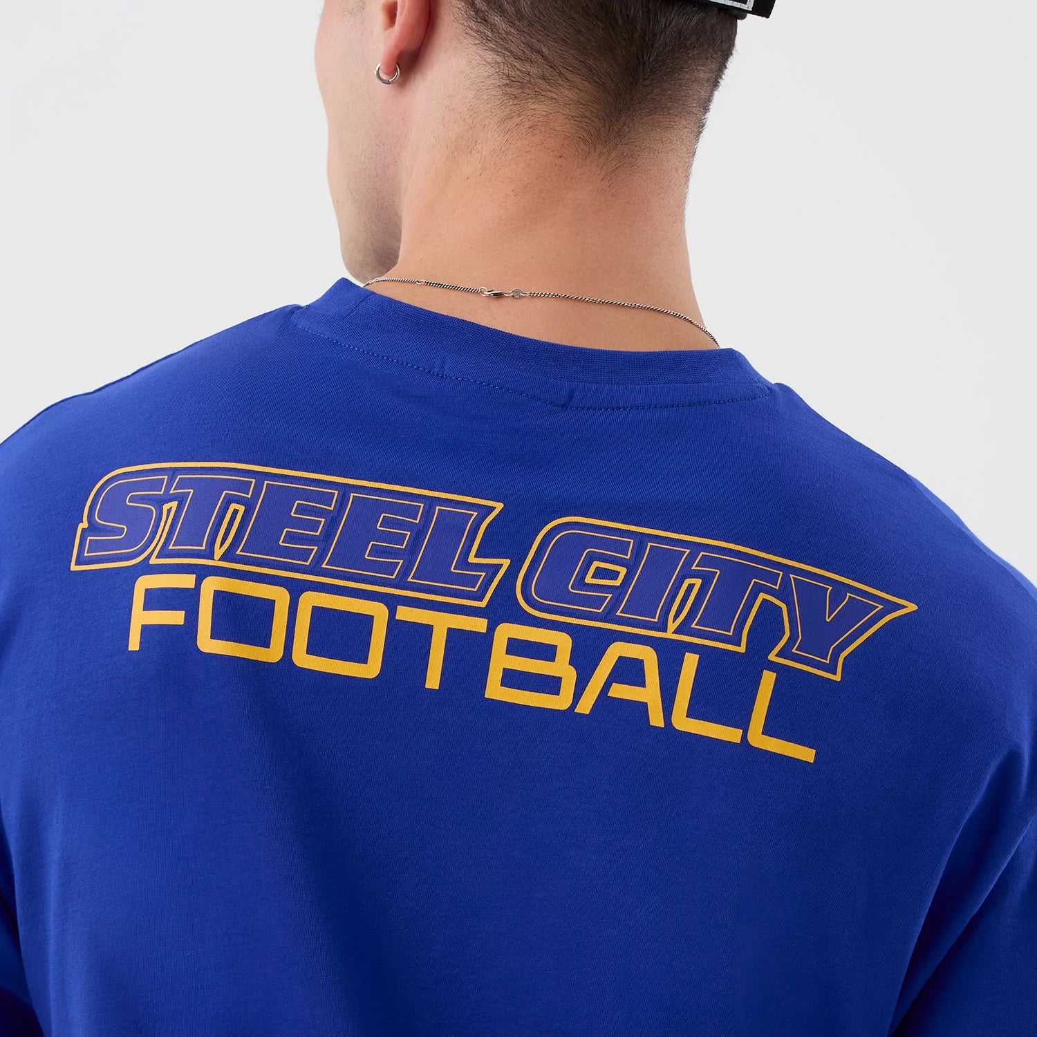 The Male model is wearing Pittsburgh Steelers NFL International Series Games Blue Oversized T-Shirt 6