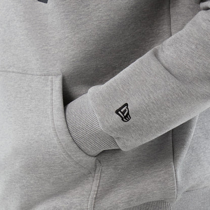 New Era Jacksonville Jaguars NFL International Series Games Grey Pullover Hoodie, three-quarter view focusing on the grey ribbed sleeve cuff with an embroidered New Era logo and a glimpse of the front kangaroo pocket.