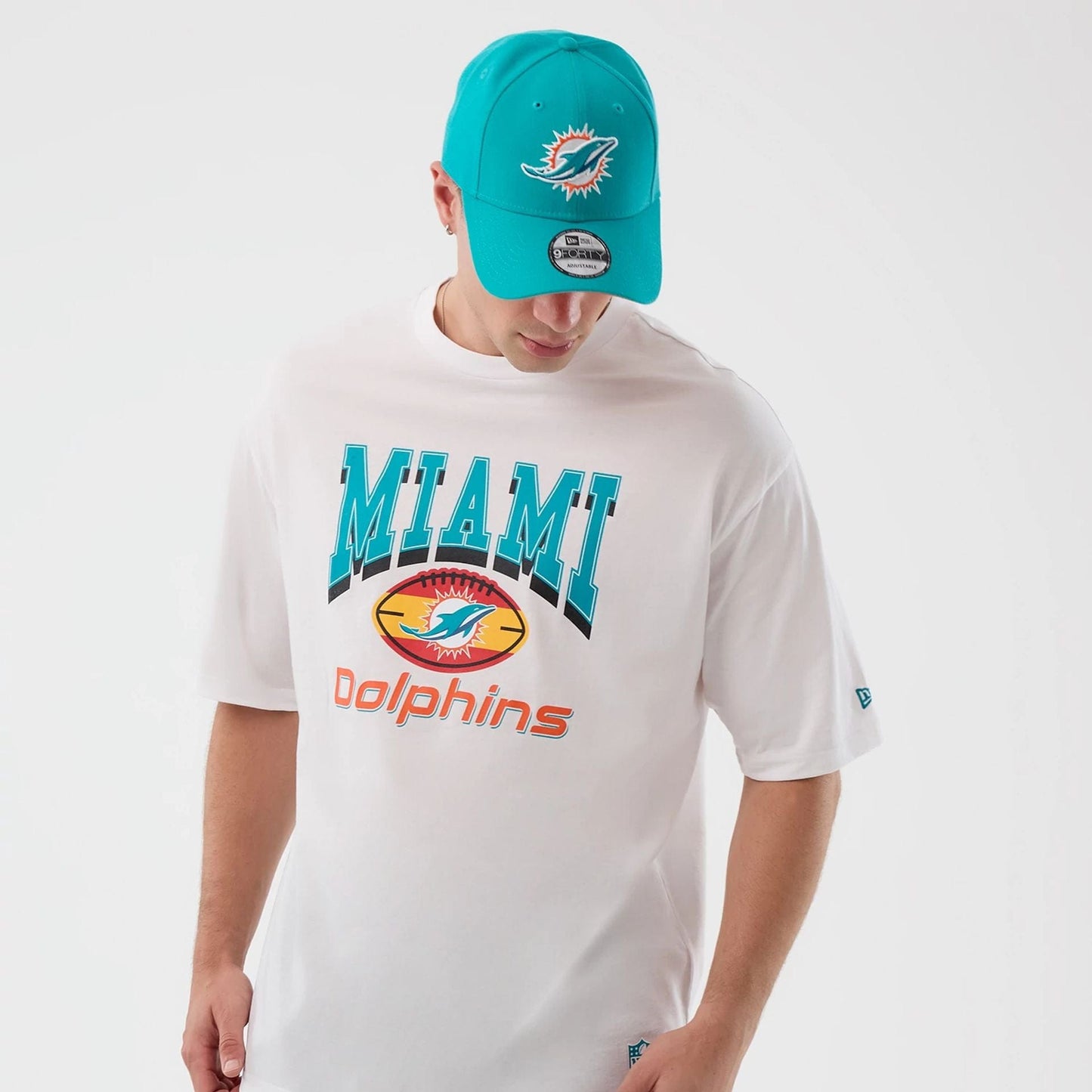The Male model is wearing Miami Dolphins NFL International Series Games White Oversized T-Shirt  3