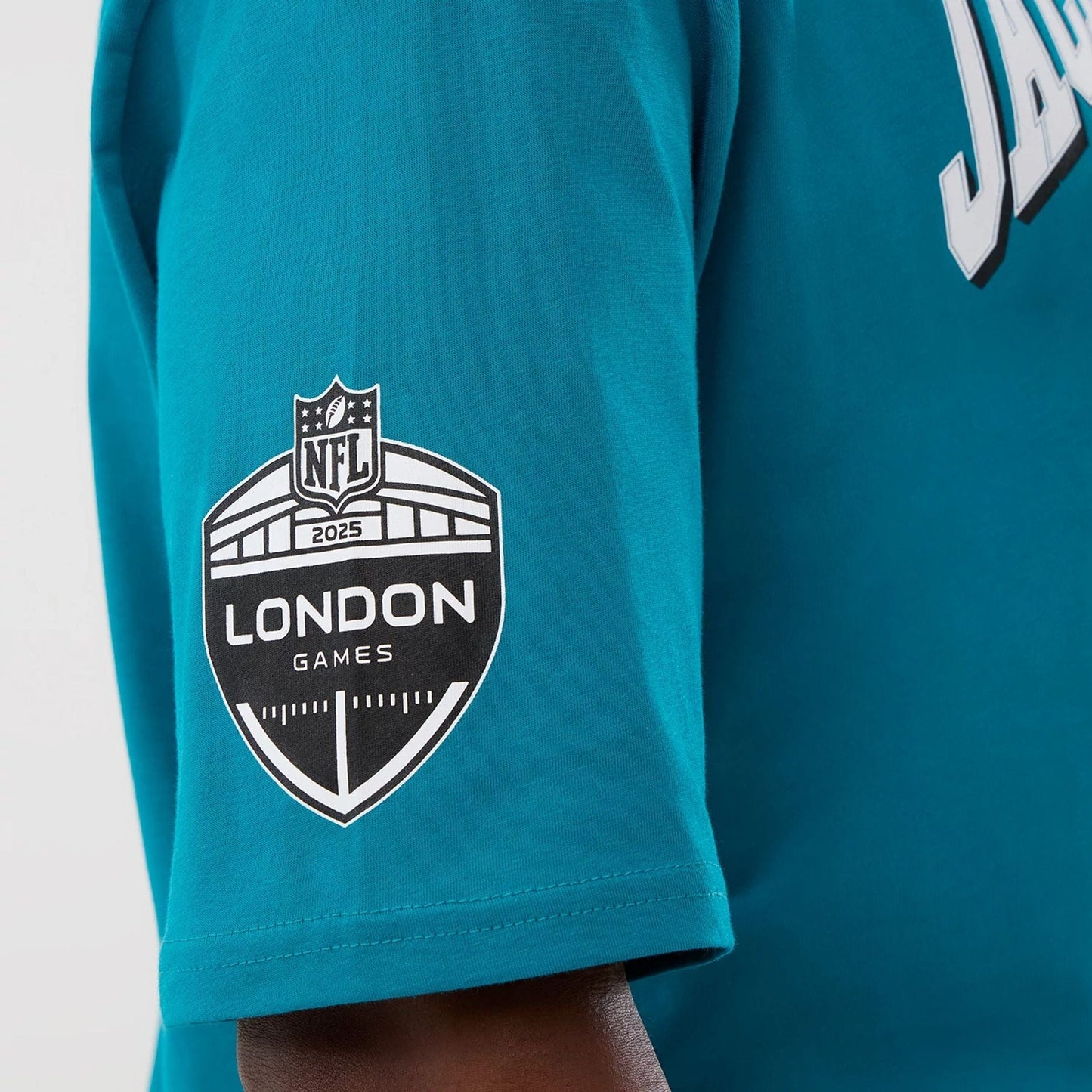 The Male model is wearing Jacksonville Jaguars NFL International Series Games Turquoise Oversized T-Shirt  3